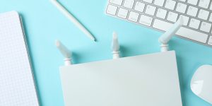 Workplace with Wi - fi router on blue background